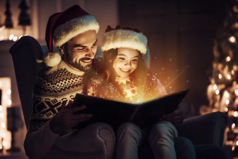 Father and daughter reading a magical holiday tale