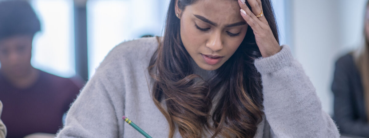 girl looking worried in exam hall