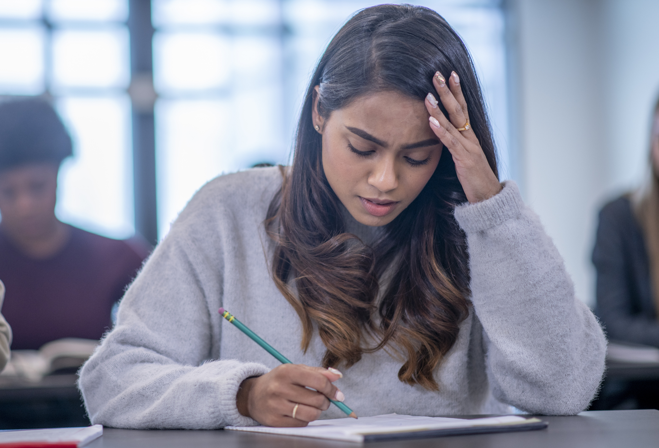 girl looking worried in exam hall